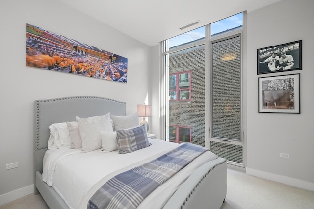 carpeted bedroom featuring baseboards and visible vents