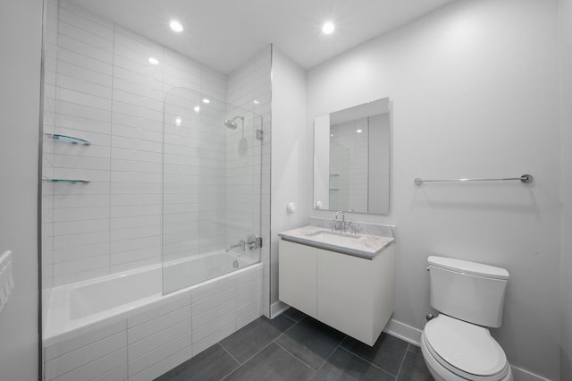 full bath featuring toilet, tiled shower / bath combo, vanity, tile patterned flooring, and baseboards