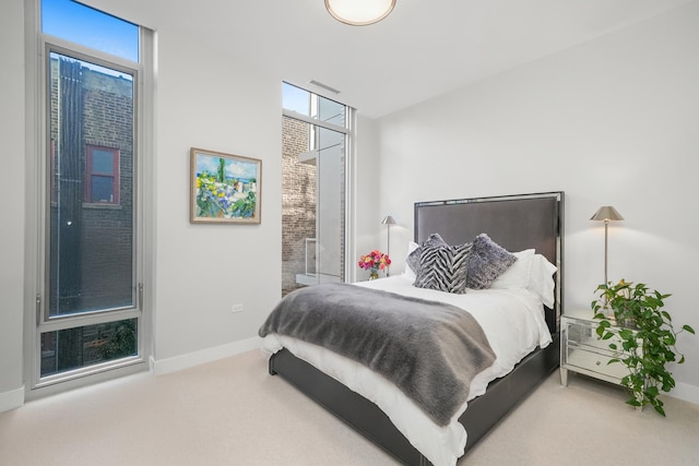 bedroom featuring carpet and baseboards