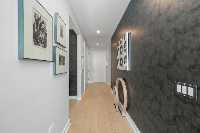 hall featuring recessed lighting, light wood-type flooring, and baseboards