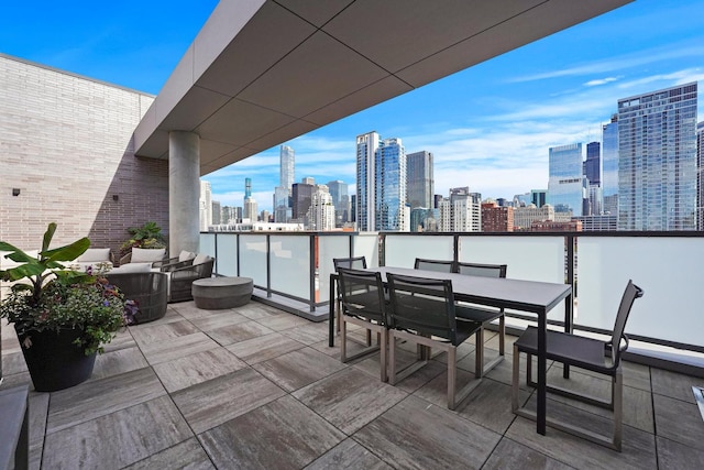 balcony with a view of city and outdoor dining space