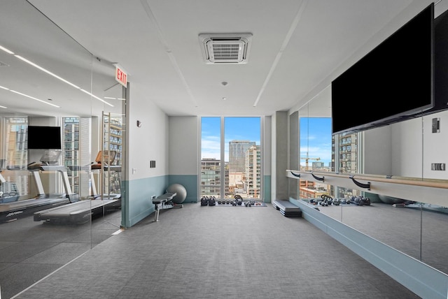 exercise room featuring visible vents and a wall of windows