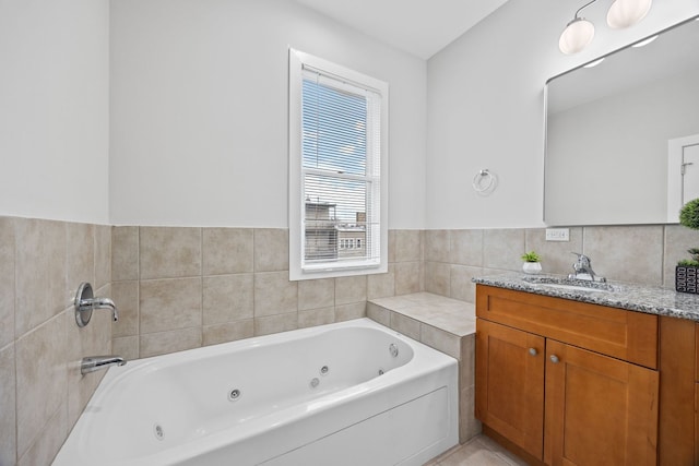 full bath featuring vanity and a jetted tub