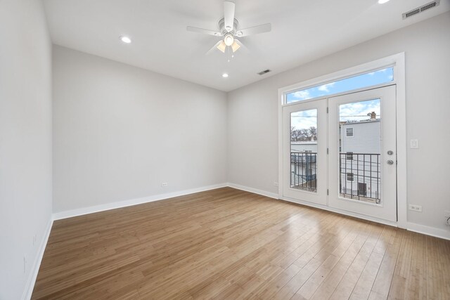 unfurnished room featuring a ceiling fan, light wood-style flooring, baseboards, and visible vents