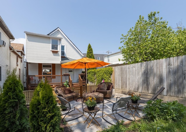 exterior space with a deck, an outdoor living space, and fence