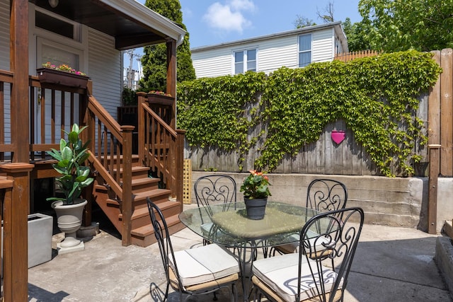 view of patio / terrace featuring outdoor dining area and fence