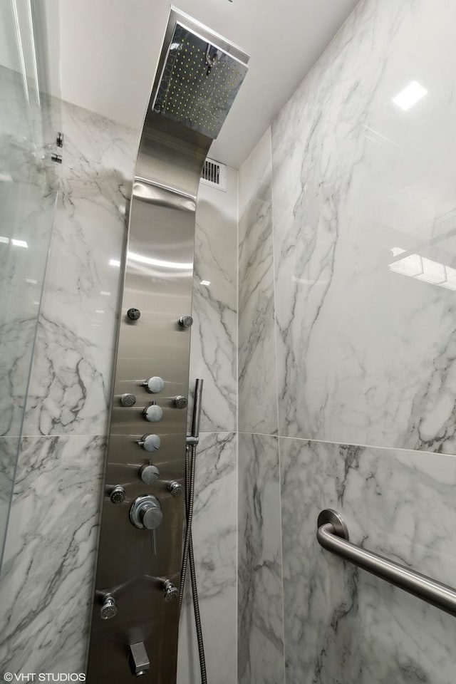 full bathroom with a marble finish shower