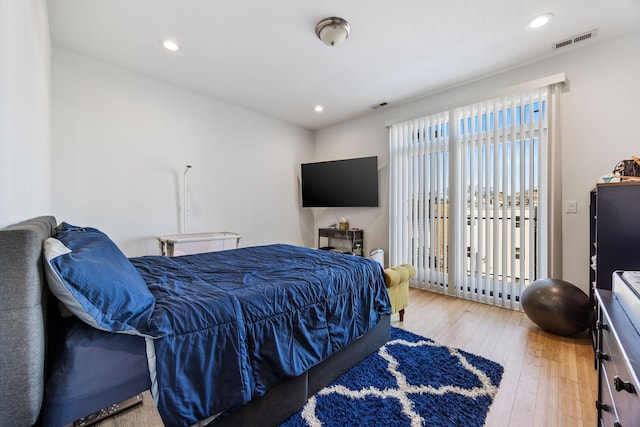 bedroom featuring access to exterior, recessed lighting, visible vents, and hardwood / wood-style flooring