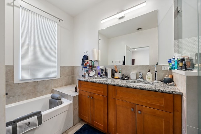 full bathroom featuring a stall shower, a garden tub, vanity, and tile walls