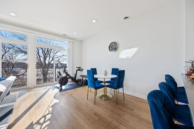 dining space with recessed lighting, visible vents, baseboards, and wood finished floors