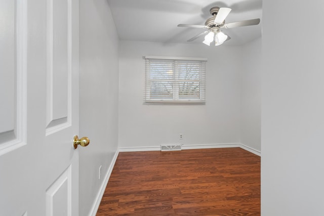 unfurnished room featuring visible vents, ceiling fan, baseboards, and wood finished floors