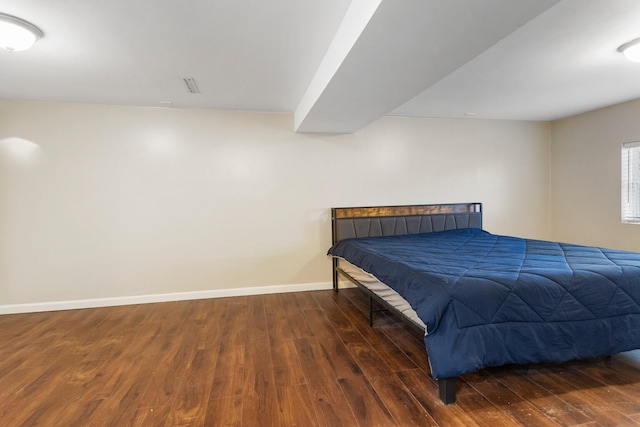 bedroom featuring hardwood / wood-style floors and baseboards