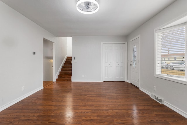 interior space featuring visible vents, stairway, baseboards, and wood finished floors