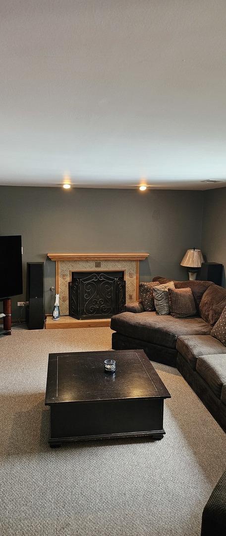 living room featuring carpet floors and a fireplace