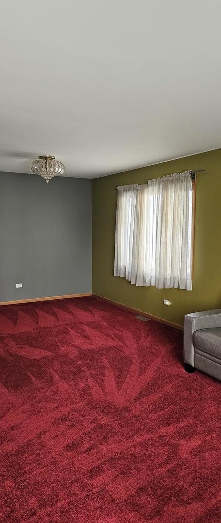 carpeted spare room with baseboards