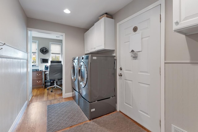 washroom with visible vents, cabinet space, light wood-style flooring, independent washer and dryer, and baseboards