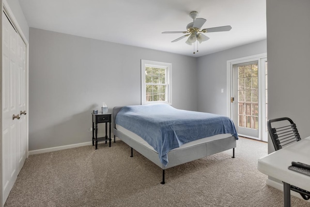 carpeted bedroom featuring access to exterior, ceiling fan, and baseboards