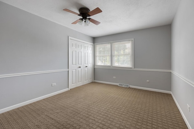 unfurnished bedroom featuring carpet, visible vents, and baseboards