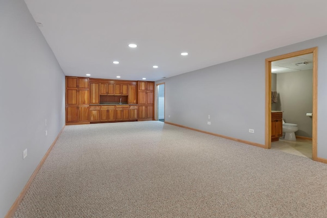 unfurnished living room with recessed lighting, light carpet, and baseboards