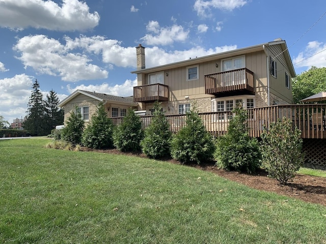 rear view of property with a chimney and a lawn