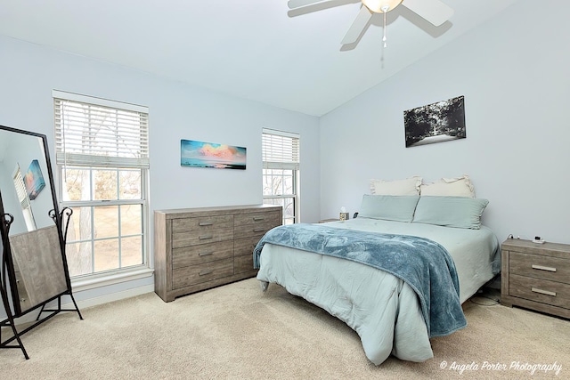 bedroom featuring lofted ceiling, carpet floors, and a ceiling fan