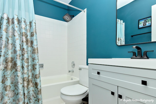 bathroom with vanity, toilet, and shower / bath combo with shower curtain