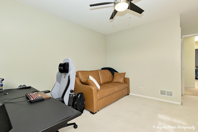 carpeted home office featuring a ceiling fan, visible vents, and baseboards