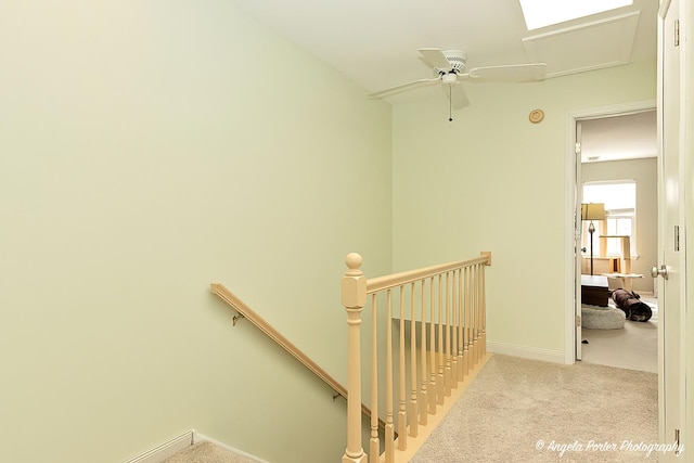 stairway with baseboards and carpet flooring