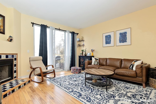 living area with a fireplace and hardwood / wood-style floors