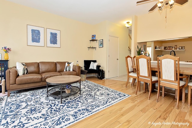 living area with light wood-type flooring and ceiling fan