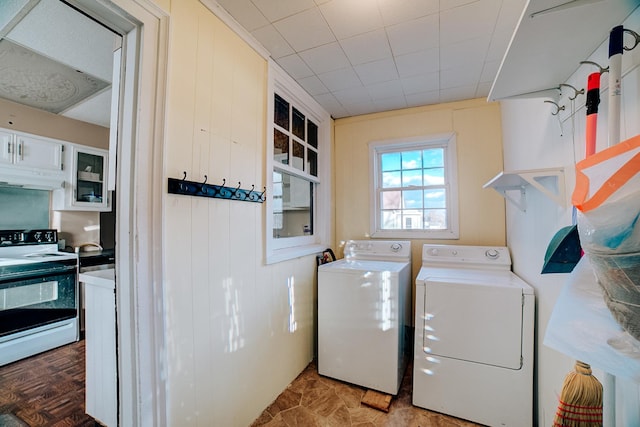 clothes washing area featuring laundry area and separate washer and dryer