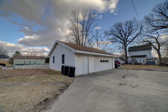 view of home's exterior with an outbuilding and a detached garage