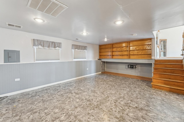 interior space with recessed lighting, wainscoting, visible vents, and electric panel