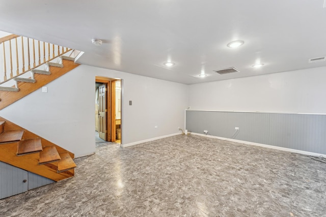 basement with visible vents, stairway, and baseboards