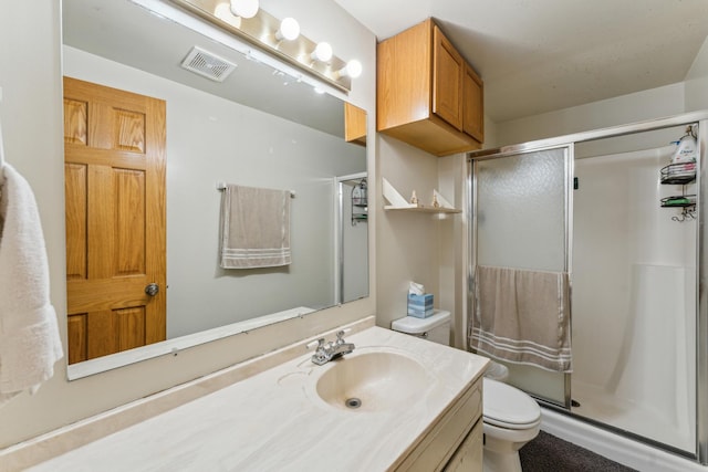 full bathroom featuring toilet, a stall shower, visible vents, and vanity