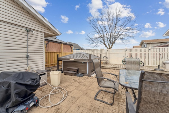 view of patio / terrace featuring outdoor dining area, a hot tub, grilling area, and a wooden deck