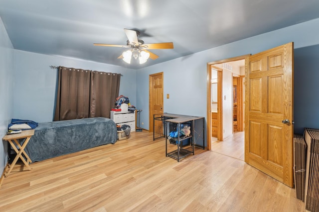 bedroom with ceiling fan, baseboards, and wood finished floors