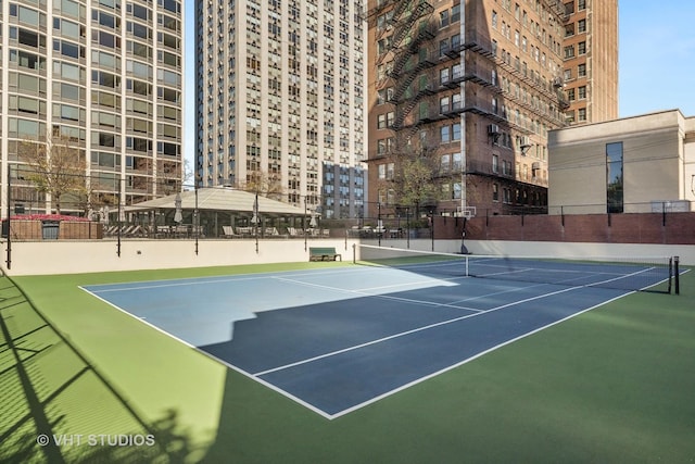 view of sport court featuring fence