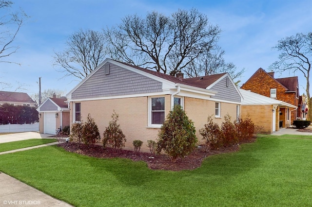 view of side of home with an attached garage, a chimney, concrete driveway, a lawn, and brick siding