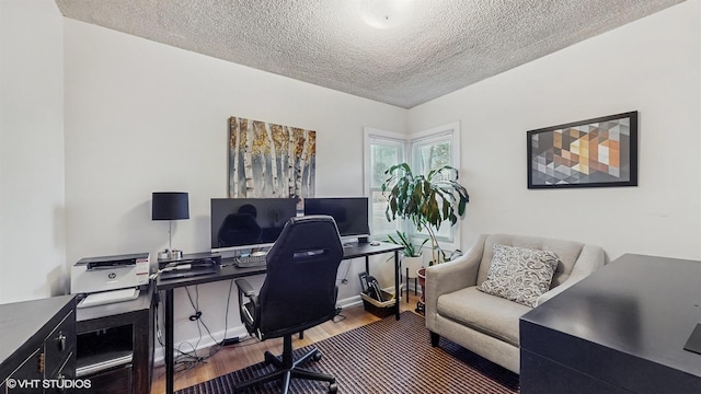 office featuring baseboards, a textured ceiling, and wood finished floors