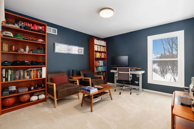 office area with a wealth of natural light, visible vents, baseboards, and carpet flooring