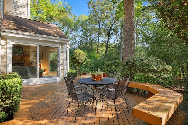 wooden terrace with outdoor dining area