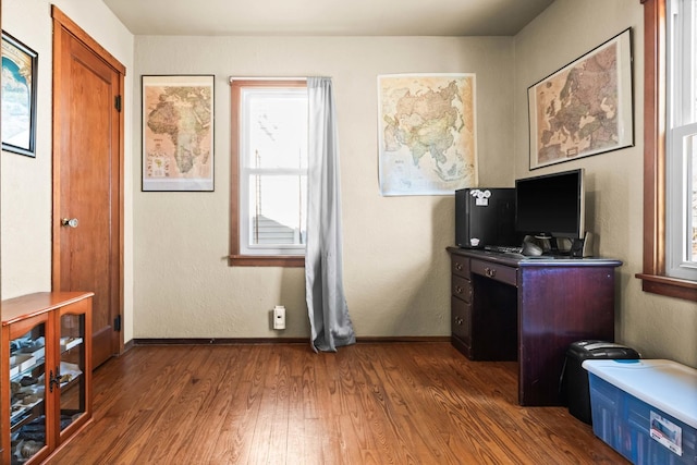 office area with baseboards and wood finished floors