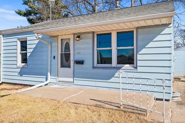 property entrance with roof with shingles