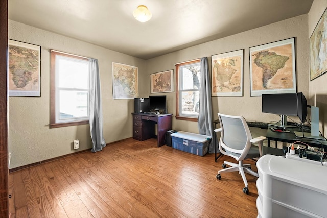 office space with a textured wall and wood finished floors