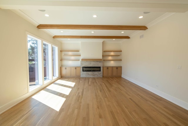 591 S Saylor Ave, Elmhurst, IL 60126 - unfurnished living room featuring baseboards, a glass covered fireplace, beam ceiling, and light wood-type flooring