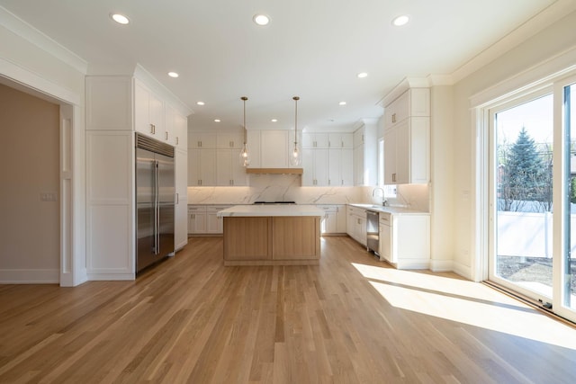 591 S Saylor Ave, Elmhurst, IL 60126 - kitchen featuring light wood finished floors, light countertops, stainless steel appliances, tasteful backsplash, and a kitchen island