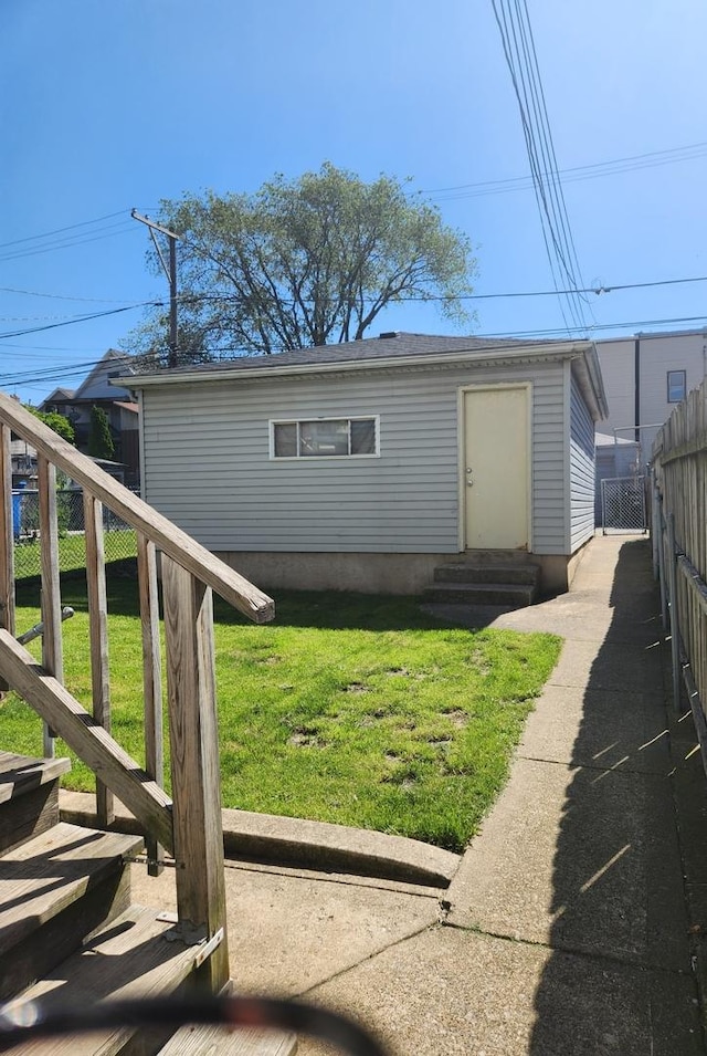 exterior space with entry steps, fence, and a front lawn