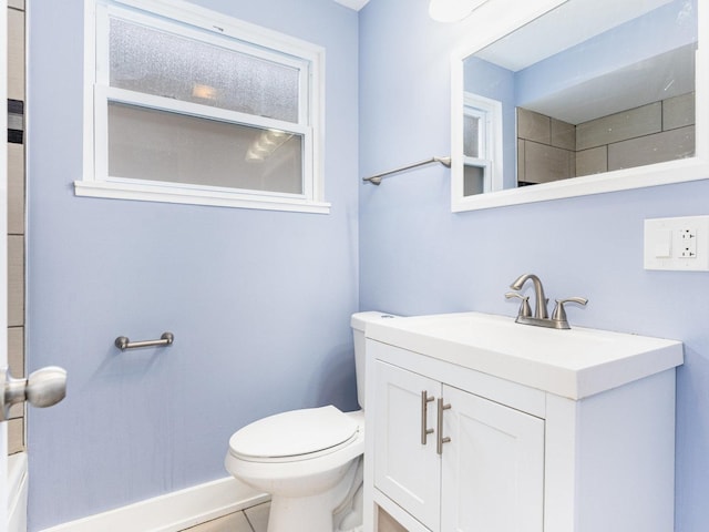 bathroom featuring toilet, tile patterned flooring, and vanity