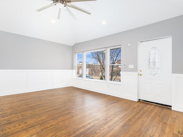 entryway featuring a ceiling fan, a wainscoted wall, wood finished floors, vaulted ceiling, and recessed lighting